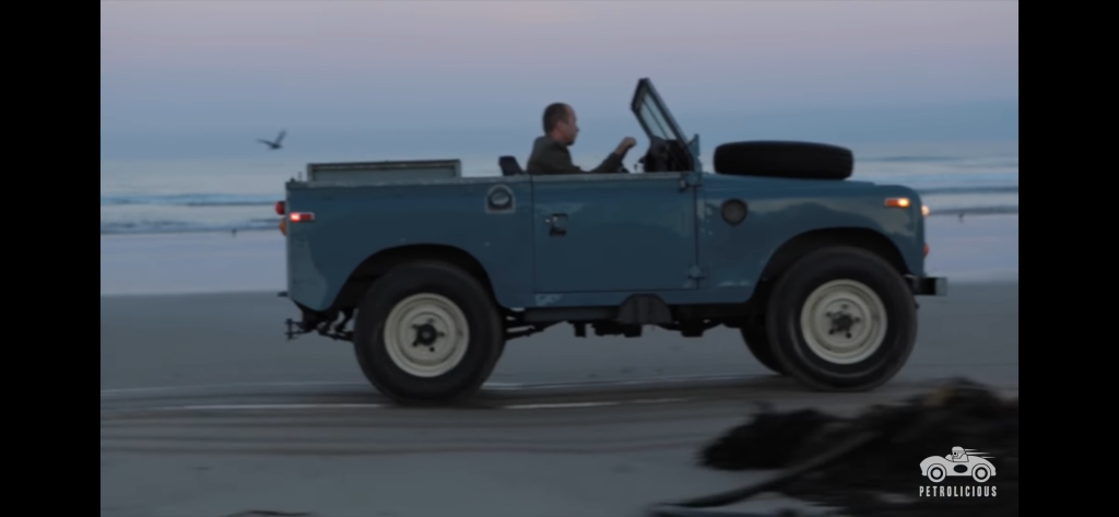 YouTube screenshot of a topless Land Rover Series 3 driving along a beach