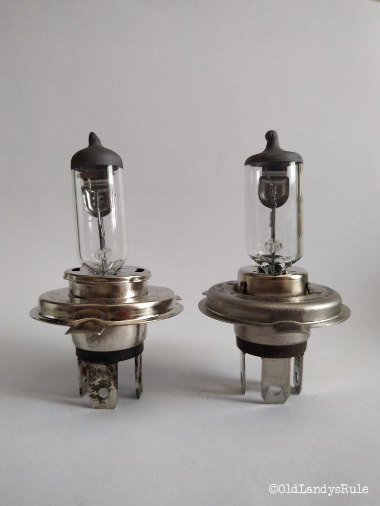 Side by side comparison of a defective bulb, from a Discovery 2 - the glass surround and filament are leaning to the left, and a 'good' bulb on the right.