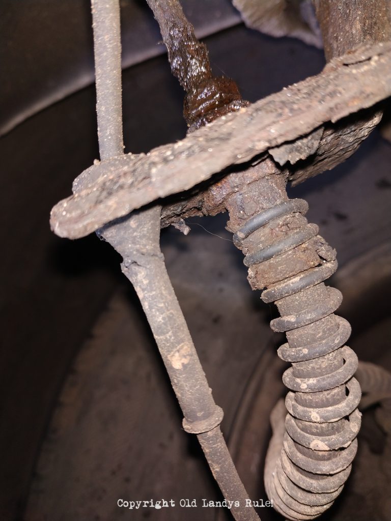 Close up of a rusty brake pipe, that's leaking, and the flexi-hose it's joined to