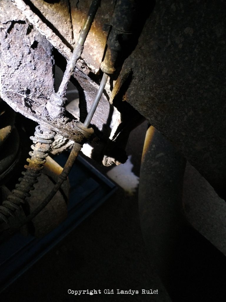 Close up of a very rusty brake pipe, where it joins to a flexi-hose